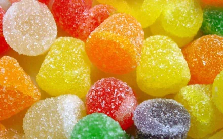 A vibrant assortment of gummy candies in various shapes and colors, adding a playful touch to your desktop wallpaper and background.