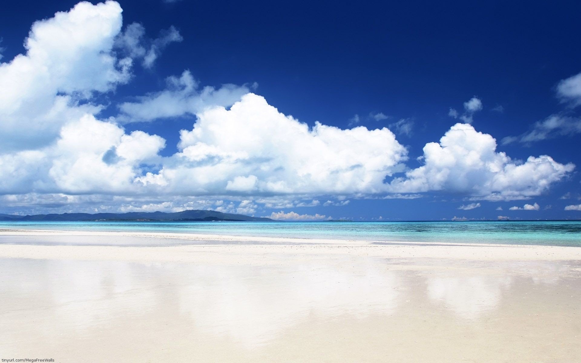 HD desktop wallpaper showcasing a serene beach with soft sand, vibrant ocean waters, and fluffy clouds under a bright blue sky.