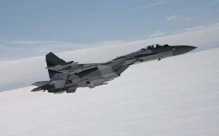 A Sukhoi Su-35 warplane soaring through the sky, showcasing its military aircraft design. This high-definition image serves as an impressive desktop wallpaper.