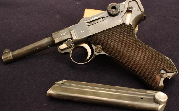 HD desktop wallpaper featuring a detailed close-up of a man-made Luger pistol with its magazine detached, set against a dark background.
