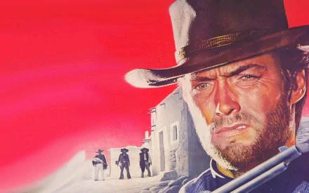 HD desktop wallpaper featuring Clint Eastwood from the movie For A Few Dollars More, showcasing a dramatic close-up with a red sky and Western town background.