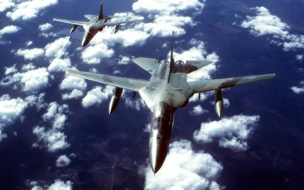 Two General Dynamics F-111 Aardvark military aircraft soar above clouds in this HD desktop wallpaper and background, tagged fb-111.