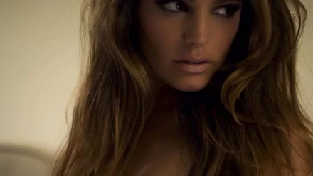 HD PC desktop wallpaper featuring a close-up portrait of celebrity Kelly Brook with flowing hair and a soft, neutral background.