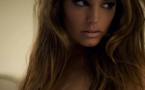 HD PC desktop wallpaper featuring a close-up portrait of celebrity Kelly Brook with flowing hair and a soft, neutral background.