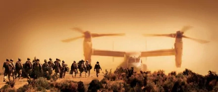 HD desktop wallpaper featuring a military Bell Boeing V-22 Osprey helicopter flying over soldiers walking through a desert landscape at sunset.