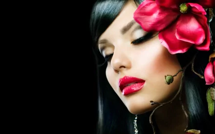 HD desktop wallpaper featuring a close-up of a woman with makeup and a large pink flower adorning her dark hair, captured by Judy Wilkins.