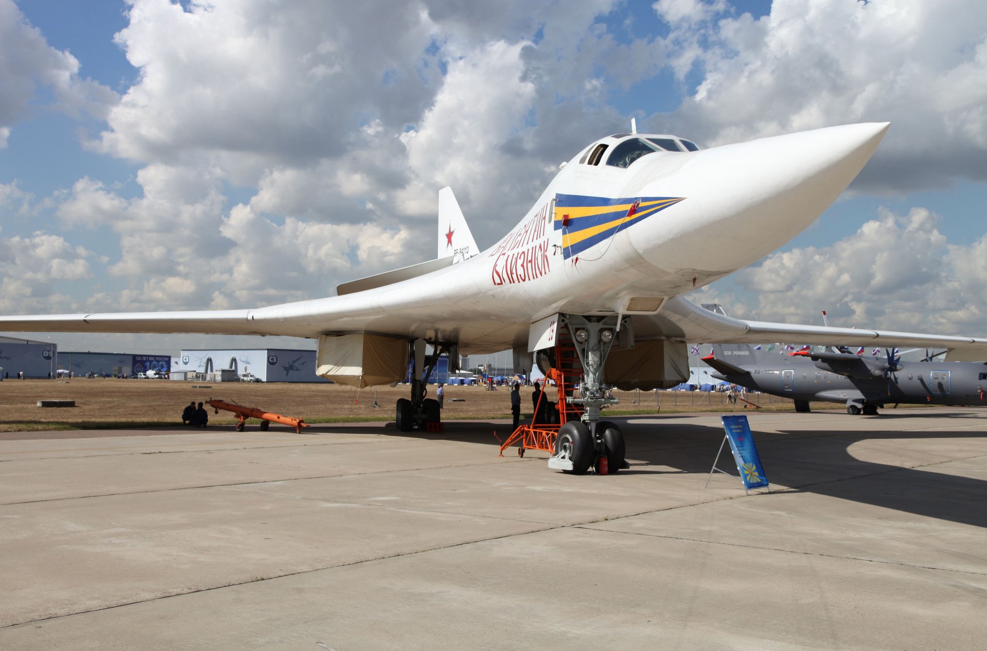 Tupolev Tu-160 combat aircraft parked on runway under a partly cloudy sky, captured in 4K Ultra HD as a military desktop wallpaper and background.