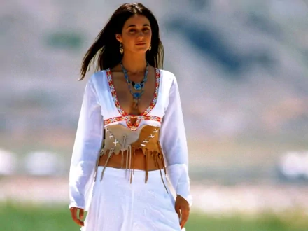 HD PC desktop wallpaper featuring celebrity Emmanuelle Chriqui in a white outfit with turquoise jewelry, set against a blurred outdoor background.