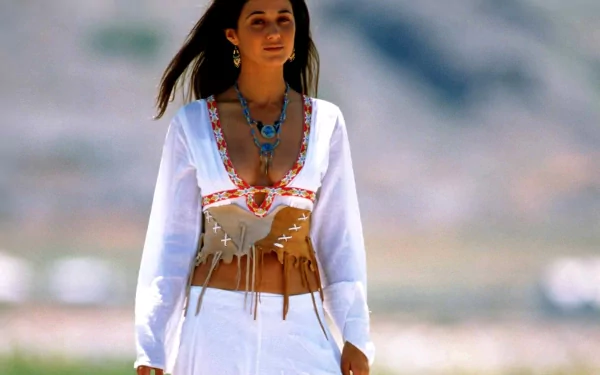 HD PC desktop wallpaper featuring celebrity Emmanuelle Chriqui in a white outfit with turquoise jewelry, set against a blurred outdoor background.