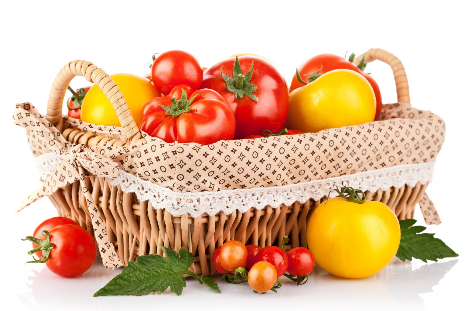 A wicker basket filled with ripe red and yellow tomatoes, surrounded by green leaves, captured in 4K Ultra HD as a vibrant PC desktop wallpaper.