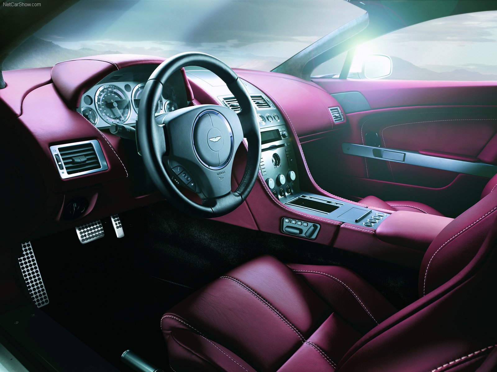 HD desktop wallpaper showcasing the luxurious interior of an Aston Martin V8 Vantage, featuring sleek, leather upholstery and a sophisticated dashboard design. Tags: Aston Martin, DB9, vehicle.