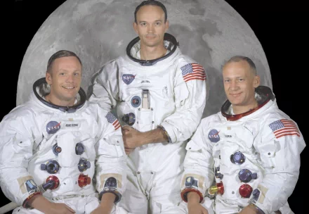 Apollo 11 crew Neil Armstrong, Buzz Aldrin, and Michael Collins in NASA spacesuits with the moon as the backdrop, captured in a 4K Ultra HD desktop wallpaper.