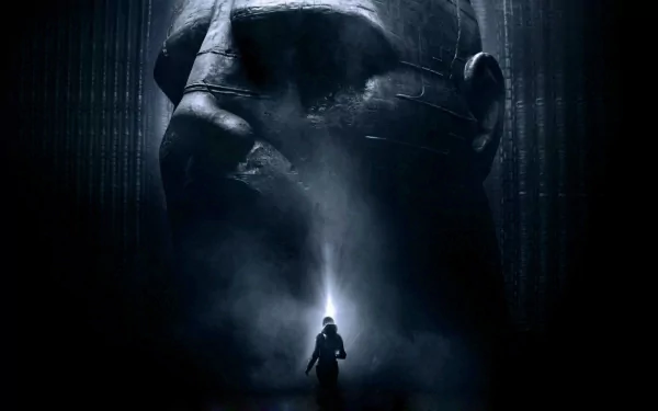 HD PC desktop wallpaper from the movie Prometheus features a lone figure standing before a massive, shadowy alien head statue in a dark, misty environment.