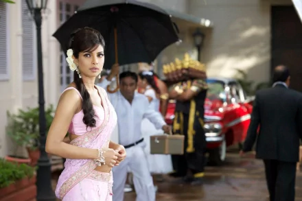 HD PC desktop wallpaper featuring celebrity Priyanka Chopra dressed in traditional attire, standing outdoors with a vintage car and crew in the background.
