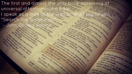 An HD desktop wallpaper featuring an open Bible with highlighted verses and text overlay of a John Quincy Adams quote advocating the importance of scriptures.