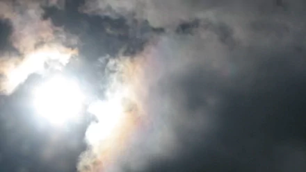 2K Quad HD PC desktop wallpaper: bright sun piercing swirling clouds in a dramatic sky — nature-themed cloud and sky background.