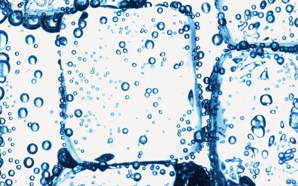 A captivating HD wallpaper featuring ice cubes submerged in water, bubbles rising around them, showcasing the beauty of nature and the cool allure of ice.