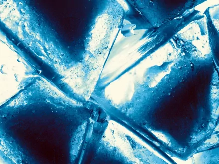 Close-up photography of ice cubes, showcasing intricate textures and reflections in vibrant blue tones, making for an attractive HD desktop wallpaper and background.