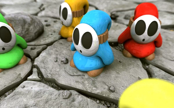 HD desktop wallpaper featuring colorful Shy Guy characters from the Super Mario video game series standing on a cracked, stony ground.