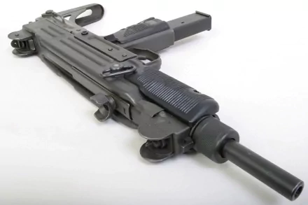 HD desktop wallpaper featuring a close-up, angled view of a man-made submachine gun on a plain white background.