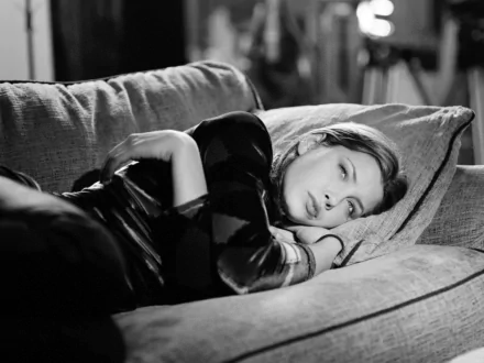 A black-and-white HD desktop wallpaper featuring celebrity Jessica Biel lounging on a couch, gazing thoughtfully while resting her head on a cushion.