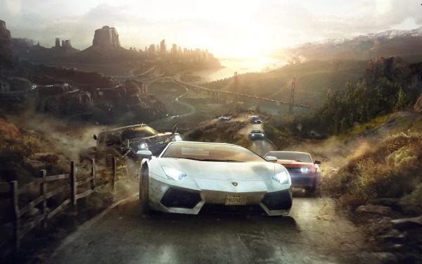 A stunning HD desktop wallpaper featuring a dynamic scene from The Crew video game, showcasing sleek cars racing through a rugged landscape with a dramatic sunset backdrop.