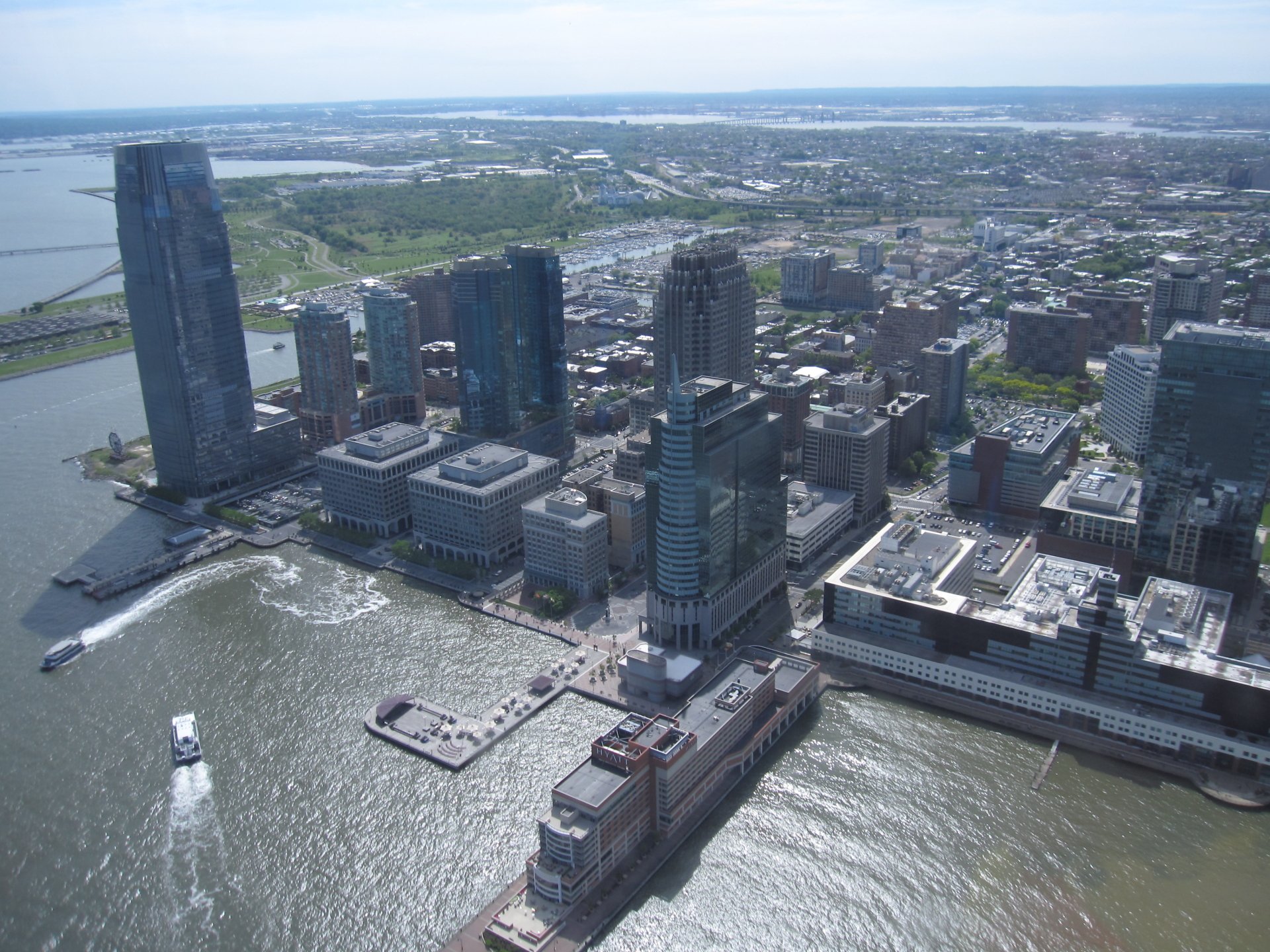 Aerial HD desktop wallpaper of Jersey City's man-made waterfront skyline with tall buildings and the surrounding cityscape.