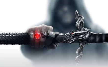 HD desktop wallpaper of Dragon Age: Inquisition featuring a close-up of a hand gripping a sword with a dragon-shaped hilt and a glowing red stone.