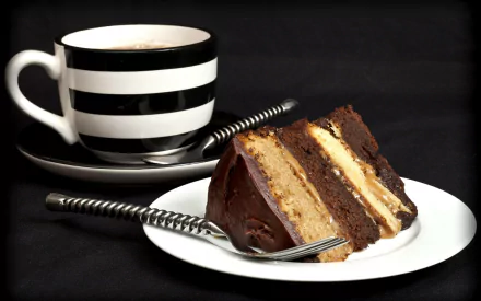 A decadent slice of chocolate cake layered with cream sits on a plate, accompanied by a black and white striped coffee cup, creating an appetizing food-themed HD desktop wallpaper.
