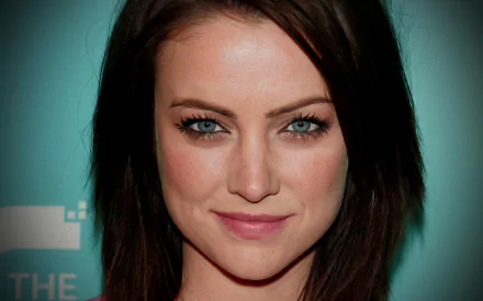 HD PC desktop wallpaper featuring a close-up portrait of celebrity Jessica Stroup with a soft smile and a teal background.