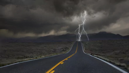 HD desktop wallpaper featuring a road stretching through a stormy landscape with a striking lightning bolt in the cloudy sky.
