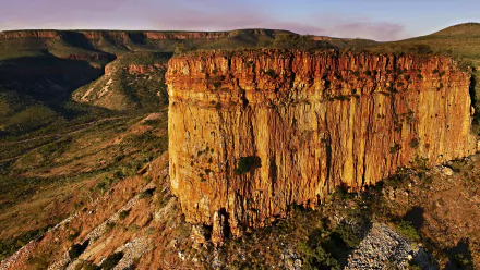 HD desktop wallpaper of rugged red rock cliffs and expansive natural landscape in the Kimberley region, showcasing its dramatic terrain and vibrant colors.