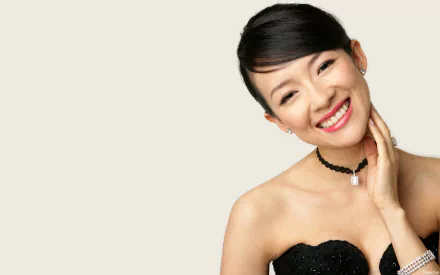 HD PC desktop wallpaper featuring celebrity Zhang Ziyi smiling, wearing a black strapless dress and choker necklace against a plain, light background.