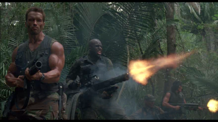 A dynamic HD desktop wallpaper from the movie Predator, featuring a muscular soldier and his team in a jungle, engaging in intense combat, surrounded by lush greenery and smoke.