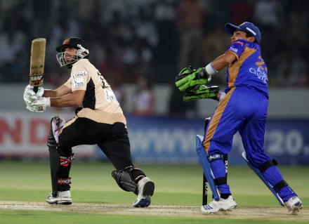 An intense moment in a cricket match with a batsman hitting the ball and the wicketkeeper in action. HD desktop wallpaper and background.