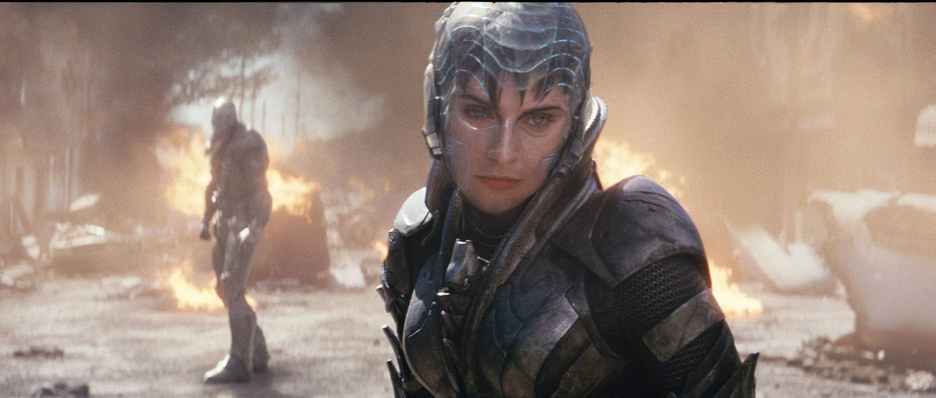 HD PC desktop wallpaper featuring a character in futuristic armor from the movie Man of Steel, set against a smoky, war-torn background.