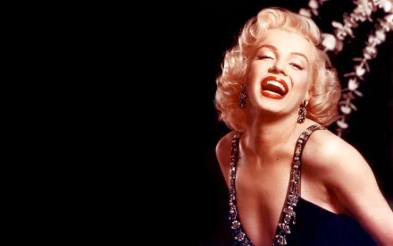 A vibrant HD wallpaper featuring actress Marilyn Monroe, showcasing her iconic smile and glamorous style against a dark background.