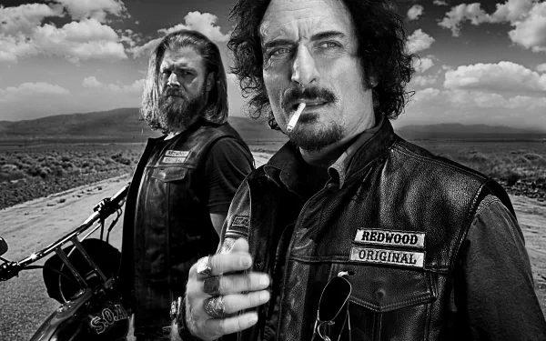 Black and white 4K Ultra HD desktop wallpaper featuring two Sons of Anarchy characters in leather vests with a dramatic cloudy sky and open road background.