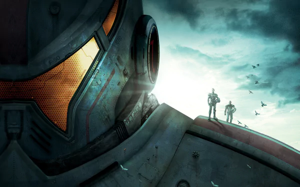A striking HD desktop wallpaper from the movie Pacific Rim, featuring the imposing head of a Jaeger and two silhouetted figures against a dramatic sky.