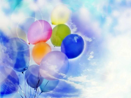 Brightly colored balloons drift against a dreamy blue sky, captured in vibrant photography, making this an engaging HD PC desktop wallpaper and background.