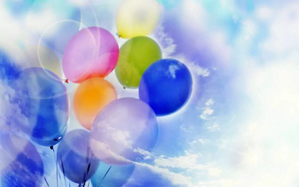 Brightly colored balloons drift against a dreamy blue sky, captured in vibrant photography, making this an engaging HD PC desktop wallpaper and background.