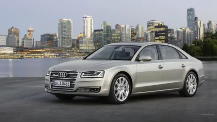 A sleek silver Audi A8 parked against a stunning city skyline, showcasing luxury and elegance in this HD PC desktop wallpaper.