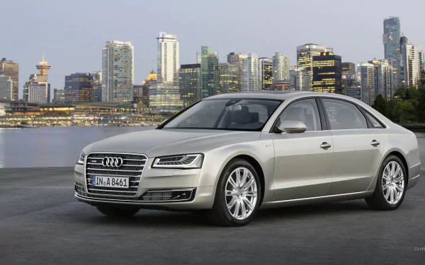 A sleek silver Audi A8 parked against a stunning city skyline, showcasing luxury and elegance in this HD PC desktop wallpaper.