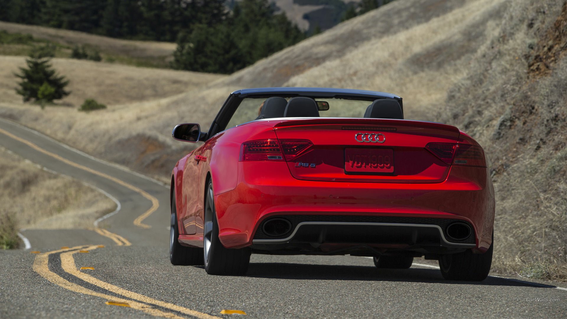 Rear view of a red Audi RS5 convertible vehicle on a winding mountain road, HD PC desktop wallpaper and background.