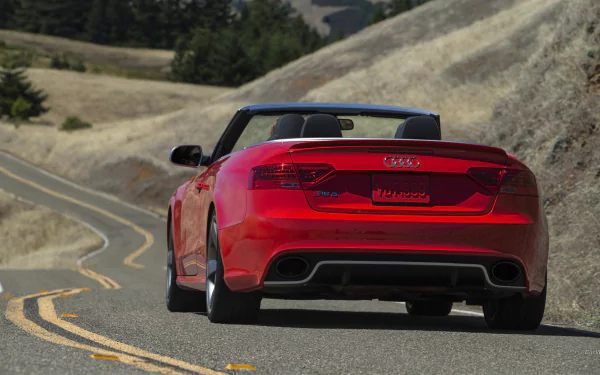 Rear view of a red Audi RS5 convertible vehicle on a winding mountain road, HD PC desktop wallpaper and background.