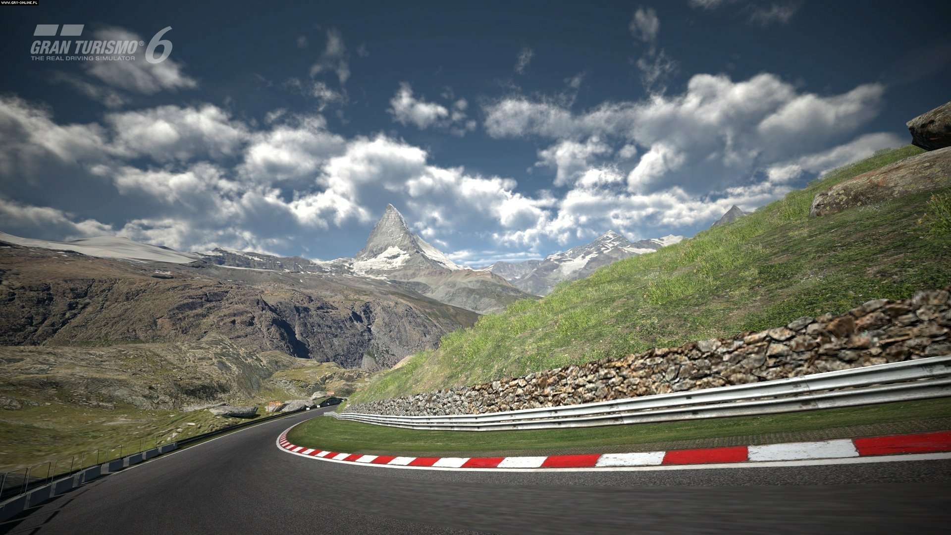 High-definition Gran Turismo 6 PC desktop wallpaper showing a winding mountain racetrack under a partly cloudy sky.