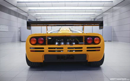 A striking McLaren F1 captured in high definition, showcasing its sleek design and distinctive rear in a modern, minimalist setting. An impressive desktop wallpaper and background option.