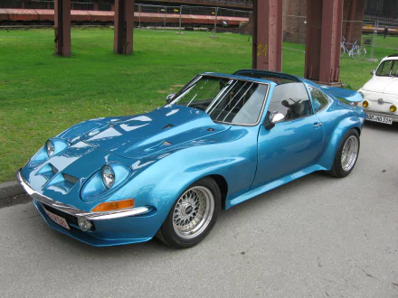 Shiny blue Opel GT sports car parked on pavement, captured as a 2K Quad HD PC desktop wallpaper and background.