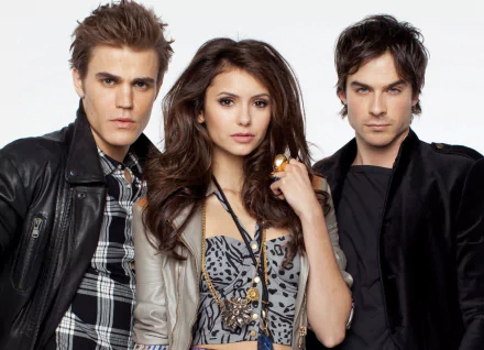 A HD desktop wallpaper featuring characters from the TV show The Vampire Diaries, showcasing a dramatic trio with striking expressions and stylish outfits.