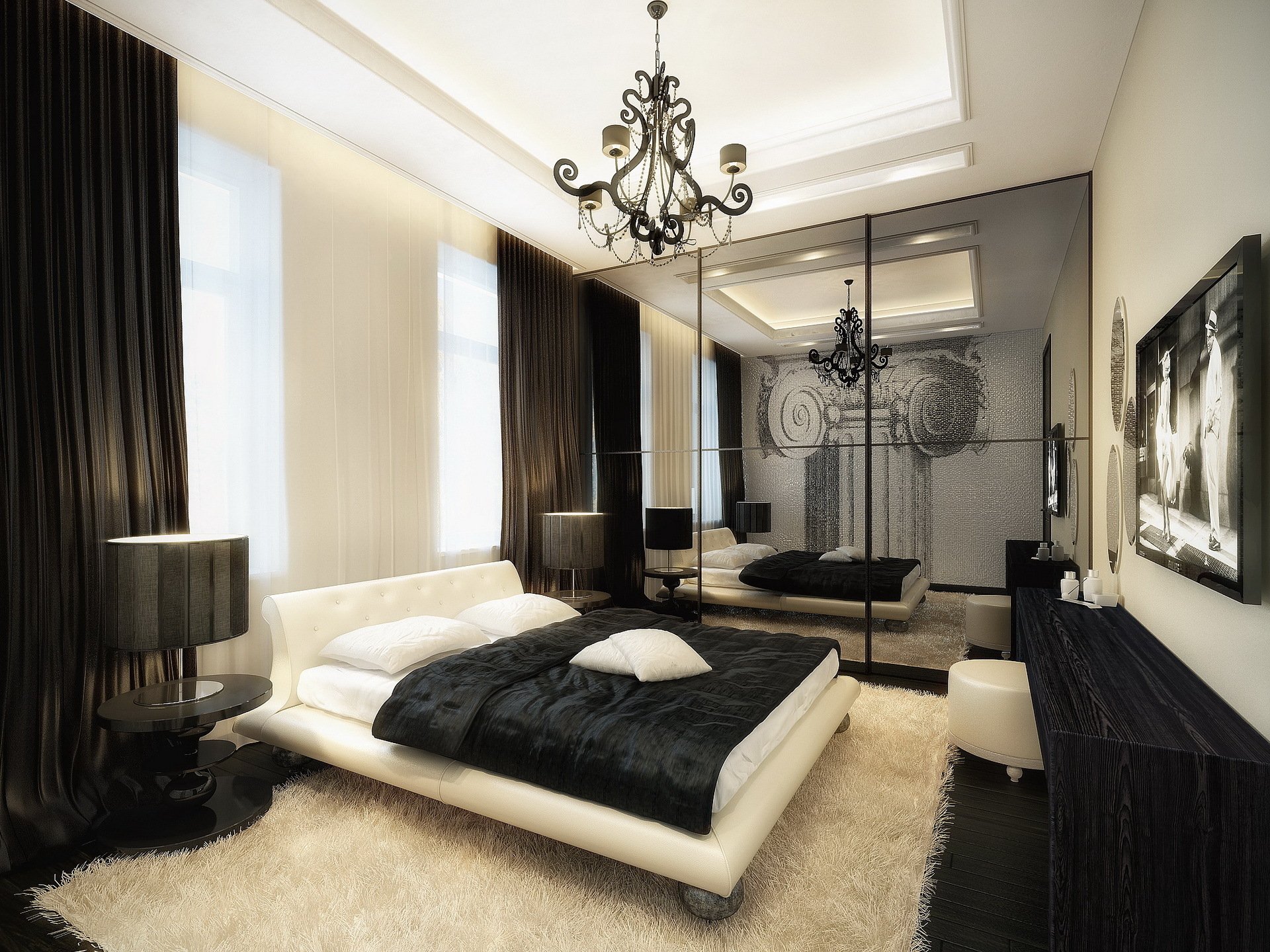 HD desktop wallpaper of a modern hotel bedroom featuring a sleek black and white color scheme, a chandelier, and reflective mirrored closet doors.